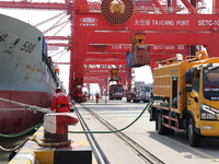 A worker is operating a machine at Taicang Port and the International Port to remove pollutants in Suzhou, Jiangsu Province, China, on March...