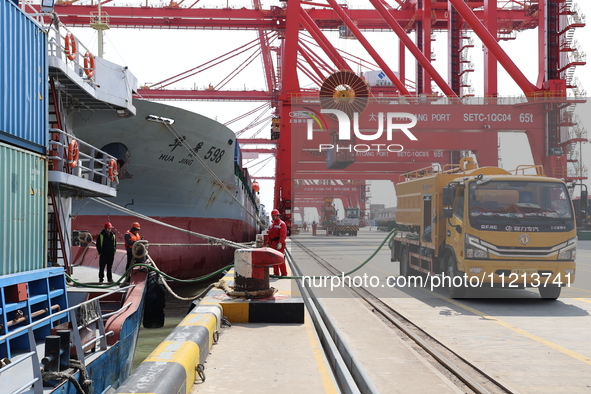 A worker is operating a machine at Taicang Port and the International Port to remove pollutants in Suzhou, Jiangsu Province, China, on March...