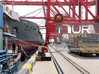 A worker is operating a machine at Taicang Port and the International Port to remove pollutants in Suzhou, Jiangsu Province, China, on March...