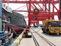 A worker is operating a machine at Taicang Port and the International Port to remove pollutants in Suzhou, Jiangsu Province, China, on March...