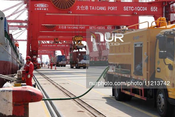 A worker is operating a machine at Taicang Port and the International Port to remove pollutants in Suzhou, Jiangsu Province, China, on March...