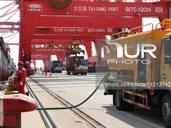 A worker is operating a machine at Taicang Port and the International Port to remove pollutants in Suzhou, Jiangsu Province, China, on March...