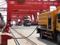 A worker is operating a machine at Taicang Port and the International Port to remove pollutants in Suzhou, Jiangsu Province, China, on March...