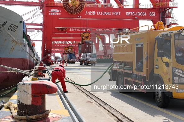 A worker is operating a machine at Taicang Port and the International Port to remove pollutants in Suzhou, Jiangsu Province, China, on March...