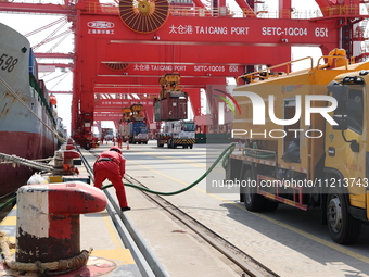 A worker is operating a machine at Taicang Port and the International Port to remove pollutants in Suzhou, Jiangsu Province, China, on March...