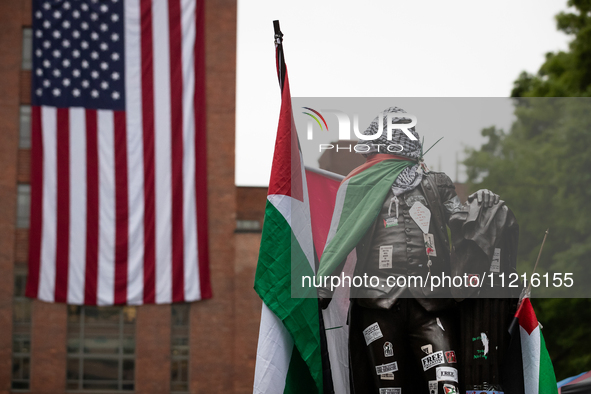 The statue of George Washington at the university that bears his name wears Palestinian flags, kefiyeh and stickers in a Gaza solidarity enc...