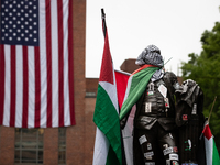 The statue of George Washington at the university that bears his name wears Palestinian flags, kefiyeh and stickers in a Gaza solidarity enc...