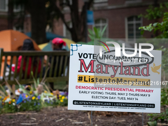 A sign at the Gaza solidarity encampment at George Washington University urges people to vote against Joe Biden in Maryland's presidential p...