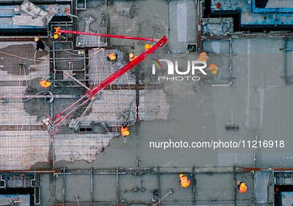 Workers are working at the real estate construction site of a resettlement housing project along the Beijing-Hangzhou Grand Canal in Huai'an...