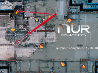 Workers are working at the real estate construction site of a resettlement housing project along the Beijing-Hangzhou Grand Canal in Huai'an...