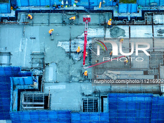 Workers are working at the real estate construction site of a resettlement housing project along the Beijing-Hangzhou Grand Canal in Huai'an...