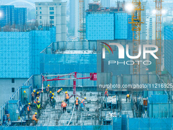 Workers are working at the real estate construction site of a resettlement housing project along the Beijing-Hangzhou Grand Canal in Huai'an...