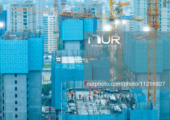 Workers are working at the real estate construction site of a resettlement housing project along the Beijing-Hangzhou Grand Canal in Huai'an...