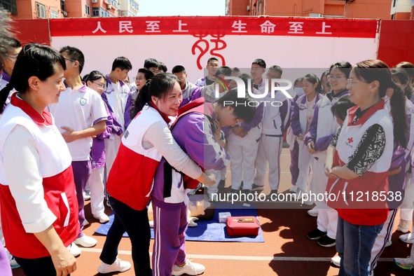 Volunteers from the Red Cross are explaining first aid at Xiyuan Middle School in Lianyungang, Jiangsu Province, East China, on May 8, 2024....