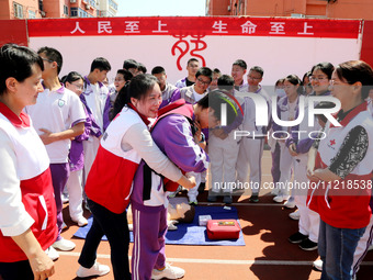 Volunteers from the Red Cross are explaining first aid at Xiyuan Middle School in Lianyungang, Jiangsu Province, East China, on May 8, 2024....