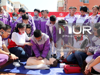 Volunteers from the Red Cross are explaining first aid at Xiyuan Middle School in Lianyungang, Jiangsu Province, East China, on May 8, 2024....