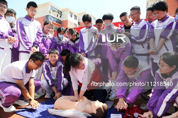 Volunteers from the Red Cross are explaining first aid at Xiyuan Middle School in Lianyungang, Jiangsu Province, East China, on May 8, 2024....