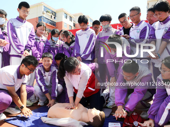 Volunteers from the Red Cross are explaining first aid at Xiyuan Middle School in Lianyungang, Jiangsu Province, East China, on May 8, 2024....