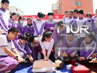 Volunteers from the Red Cross are explaining first aid at Xiyuan Middle School in Lianyungang, Jiangsu Province, East China, on May 8, 2024....