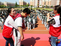 Volunteers from the Red Cross are explaining first aid at Xiyuan Middle School in Lianyungang, Jiangsu Province, East China, on May 8, 2024....