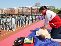 Volunteers from the Red Cross are explaining first aid at Xiyuan Middle School in Lianyungang, Jiangsu Province, East China, on May 8, 2024....