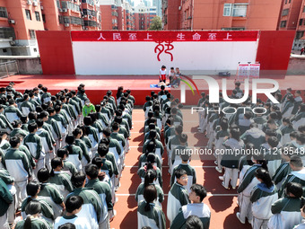 Volunteers from the Red Cross are explaining first aid at Xiyuan Middle School in Lianyungang, Jiangsu Province, East China, on May 8, 2024....