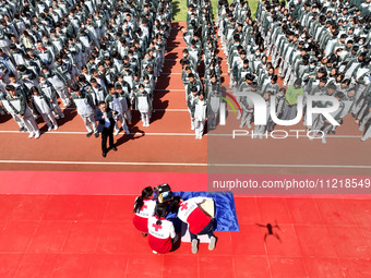 Volunteers from the Red Cross are explaining first aid at Xiyuan Middle School in Lianyungang, Jiangsu Province, East China, on May 8, 2024....