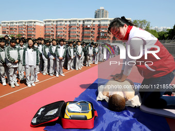 Volunteers from the Red Cross are explaining first aid at Xiyuan Middle School in Lianyungang, Jiangsu Province, East China, on May 8, 2024....