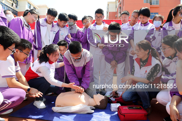 Volunteers from the Red Cross are explaining first aid at Xiyuan Middle School in Lianyungang, Jiangsu Province, East China, on May 8, 2024....