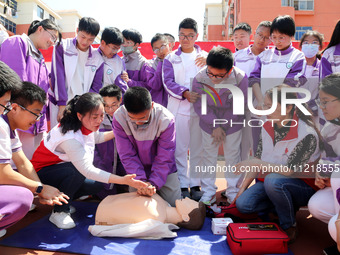 Volunteers from the Red Cross are explaining first aid at Xiyuan Middle School in Lianyungang, Jiangsu Province, East China, on May 8, 2024....