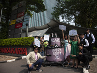 Environmental activists from Enter Nusantara, Market Force, and Greenpeace Indonesia, who are part of the Civil Society Coalition, are perfo...