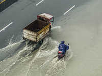 Cars are wading through a flooded road amid an orange rainstorm alert in Nanning, Guangxi Province, China, on May 8, 2024. (