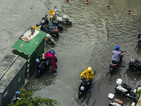 Cars are wading through a flooded road amid an orange rainstorm alert in Nanning, Guangxi Province, China, on May 8, 2024. (