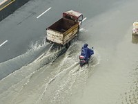 Cars are wading through a flooded road amid an orange rainstorm alert in Nanning, Guangxi Province, China, on May 8, 2024. (