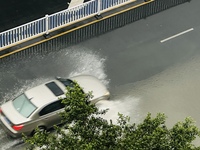 Cars are wading through a flooded road amid an orange rainstorm alert in Nanning, Guangxi Province, China, on May 8, 2024. (