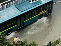 Cars are wading through a flooded road amid an orange rainstorm alert in Nanning, Guangxi Province, China, on May 8, 2024. (