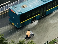 Cars are wading through a flooded road amid an orange rainstorm alert in Nanning, Guangxi Province, China, on May 8, 2024. (