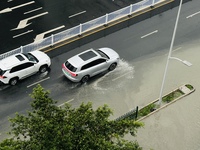 Cars are wading through a flooded road amid an orange rainstorm alert in Nanning, Guangxi Province, China, on May 8, 2024. (