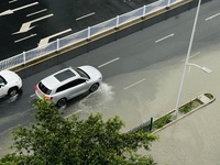 Cars are wading through a flooded road amid an orange rainstorm alert in Nanning, Guangxi Province, China, on May 8, 2024. (