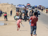 Displaced Palestinians are filling jerrycans with water at a desalination plant in Deir el-Balah in the central Gaza Strip, on May 8, 2024,...