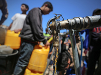 Displaced Palestinians are filling jerrycans with water at a desalination plant in Deir el-Balah in the central Gaza Strip, on May 8, 2024,...