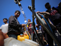 Displaced Palestinians are filling jerrycans with water at a desalination plant in Deir el-Balah in the central Gaza Strip, on May 8, 2024,...