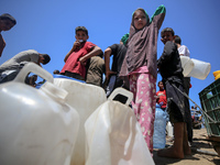 Displaced Palestinians are filling jerrycans with water at a desalination plant in Deir el-Balah in the central Gaza Strip, on May 8, 2024,...