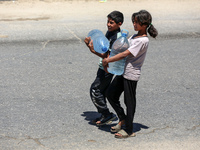 Displaced Palestinians are filling jerrycans with water at a desalination plant in Deir el-Balah in the central Gaza Strip, on May 8, 2024,...