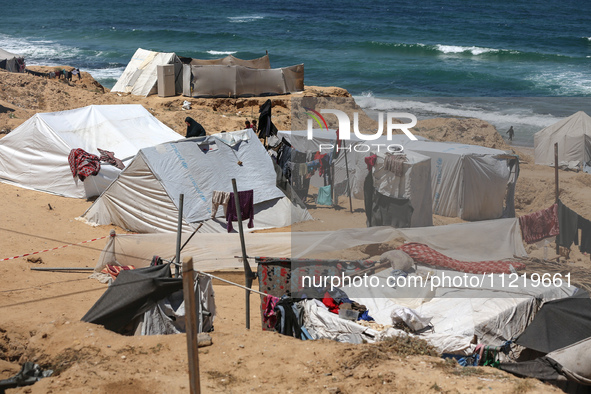 Displaced Palestinians are setting up tents on a beach near Deir el-Balah in the central Gaza Strip amid the ongoing conflict between Israel...