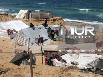 Displaced Palestinians are setting up tents on a beach near Deir el-Balah in the central Gaza Strip amid the ongoing conflict between Israel...