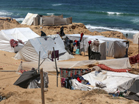 Displaced Palestinians are setting up tents on a beach near Deir el-Balah in the central Gaza Strip amid the ongoing conflict between Israel...