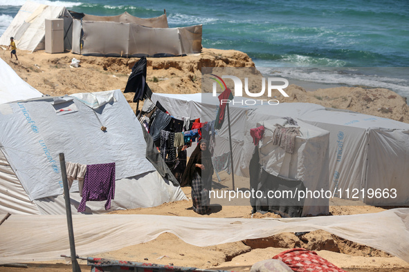 Displaced Palestinians are setting up tents on a beach near Deir el-Balah in the central Gaza Strip amid the ongoing conflict between Israel...