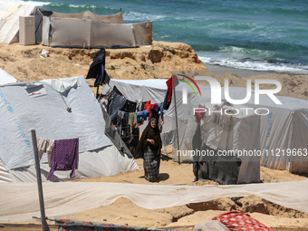 Displaced Palestinians are setting up tents on a beach near Deir el-Balah in the central Gaza Strip amid the ongoing conflict between Israel...