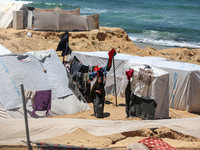 Displaced Palestinians are setting up tents on a beach near Deir el-Balah in the central Gaza Strip amid the ongoing conflict between Israel...